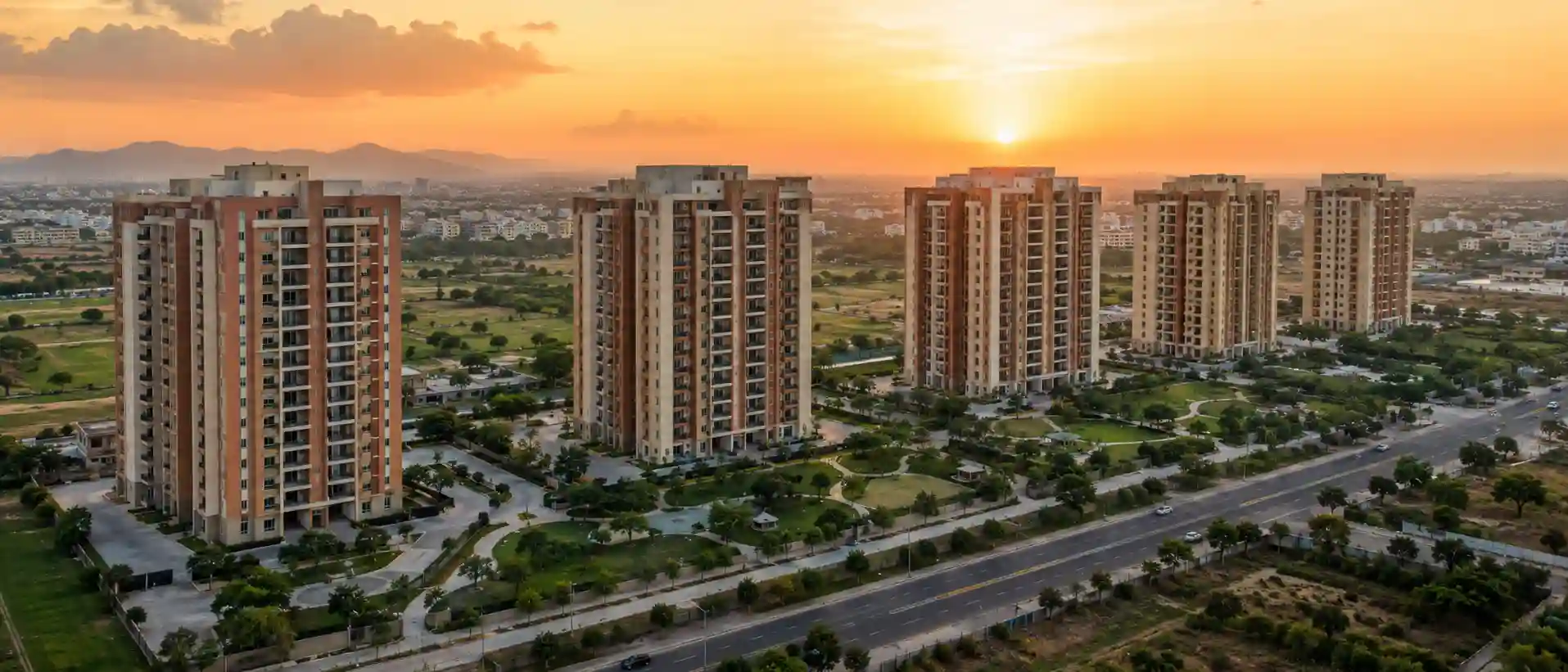 Aerial view of residential apartment towers representing the best 3 BHK flats in Jaipur at sunset